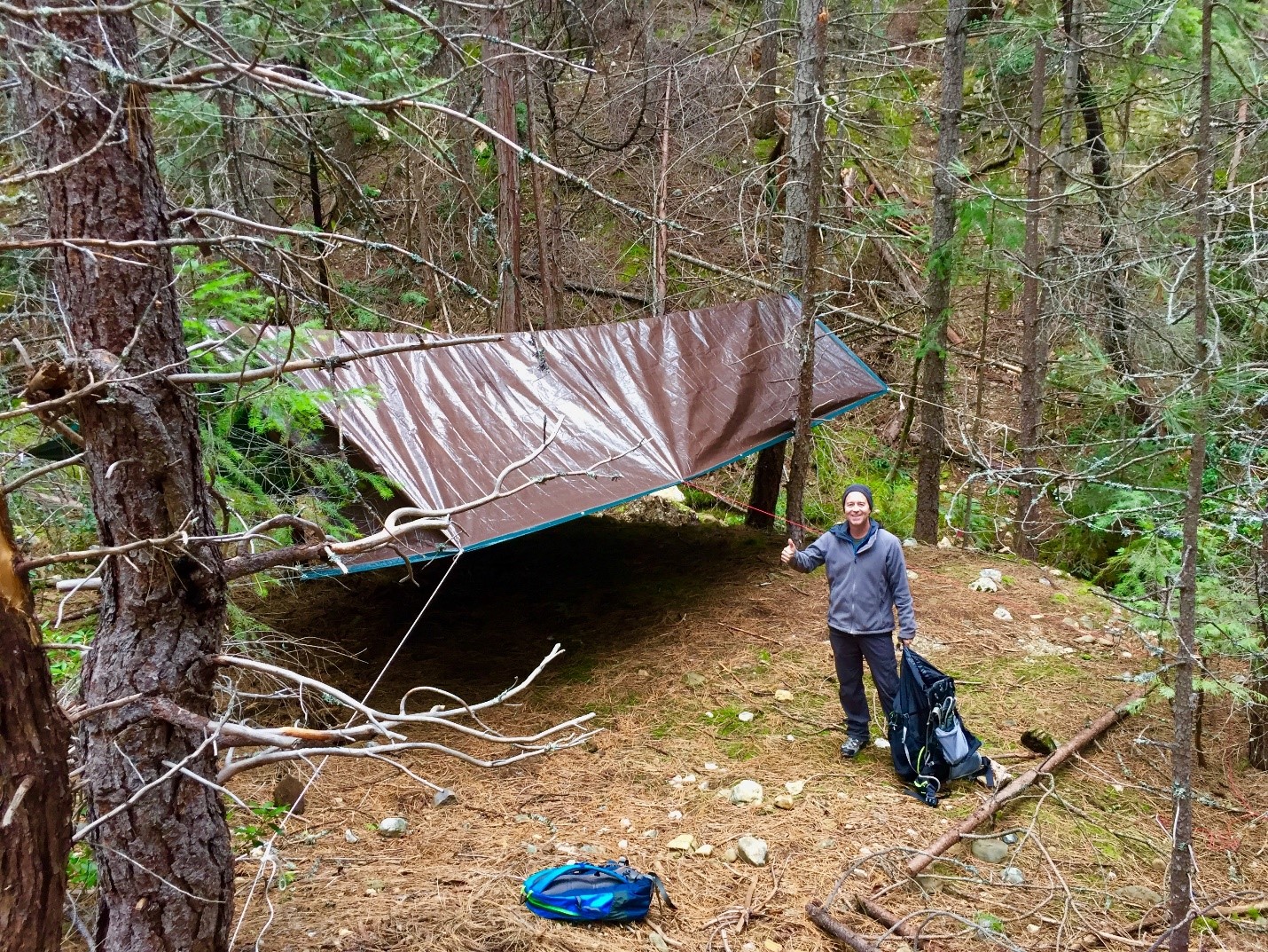 Volunteer Brennan Johnston set up the tarp for the overnight storm sampling on Scotchman Creek