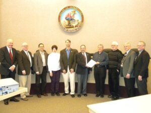 Nevada County Board of Supervisors displaying resolution to support Bridgeport Covered Bridge renovation.