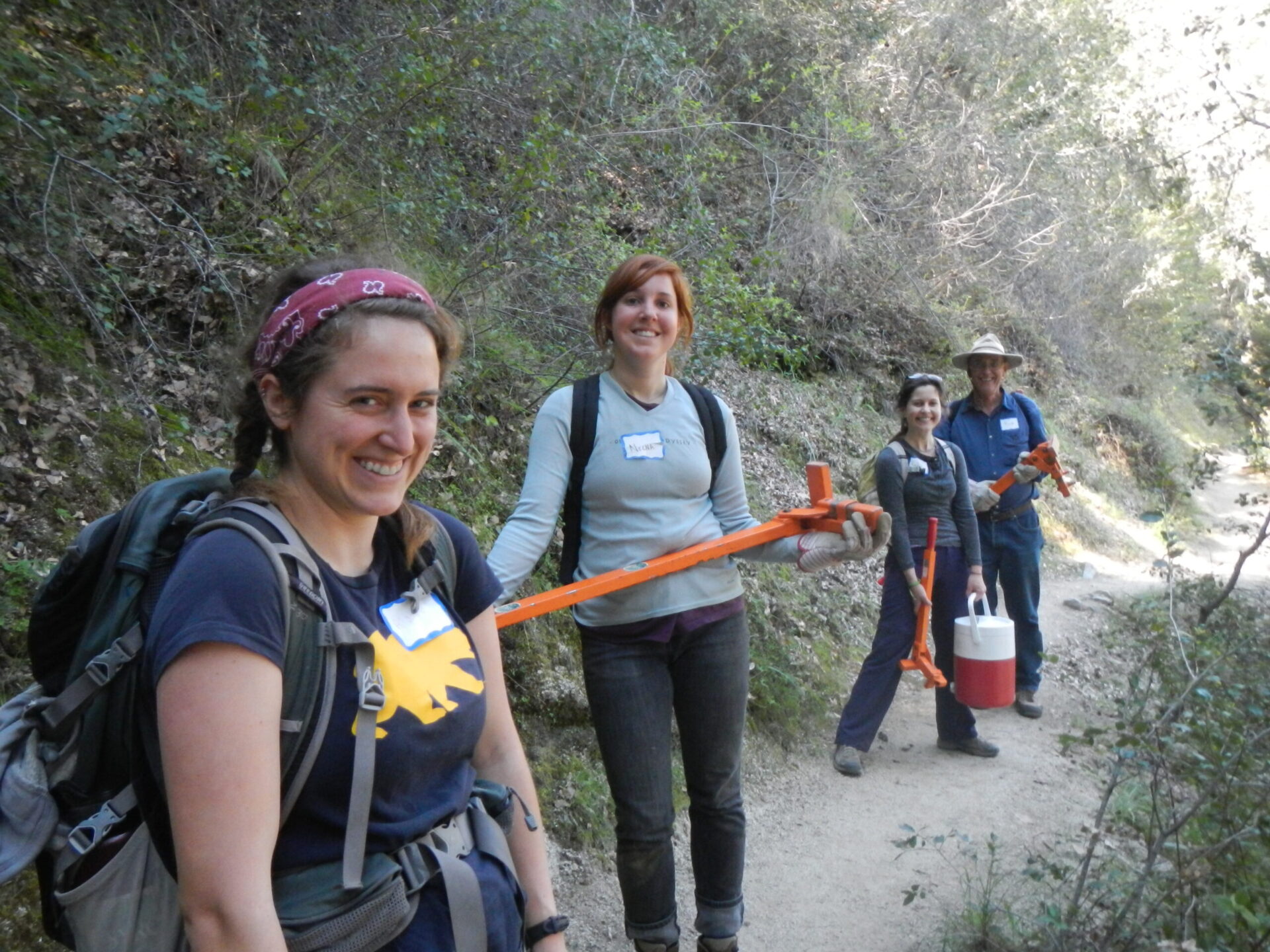 Volunteers hiking in with tools